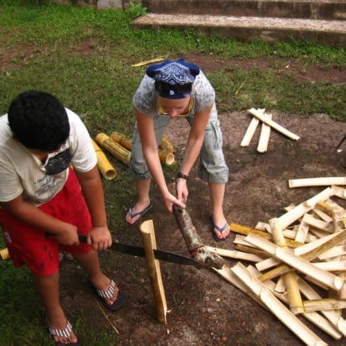Alexandra Wilson building a school compost bin from bamboo.