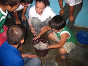 Alexandra Wilson teaching a group of elementary school kids how to make recycled paper. (Courtesy of Alexandra Wilson)