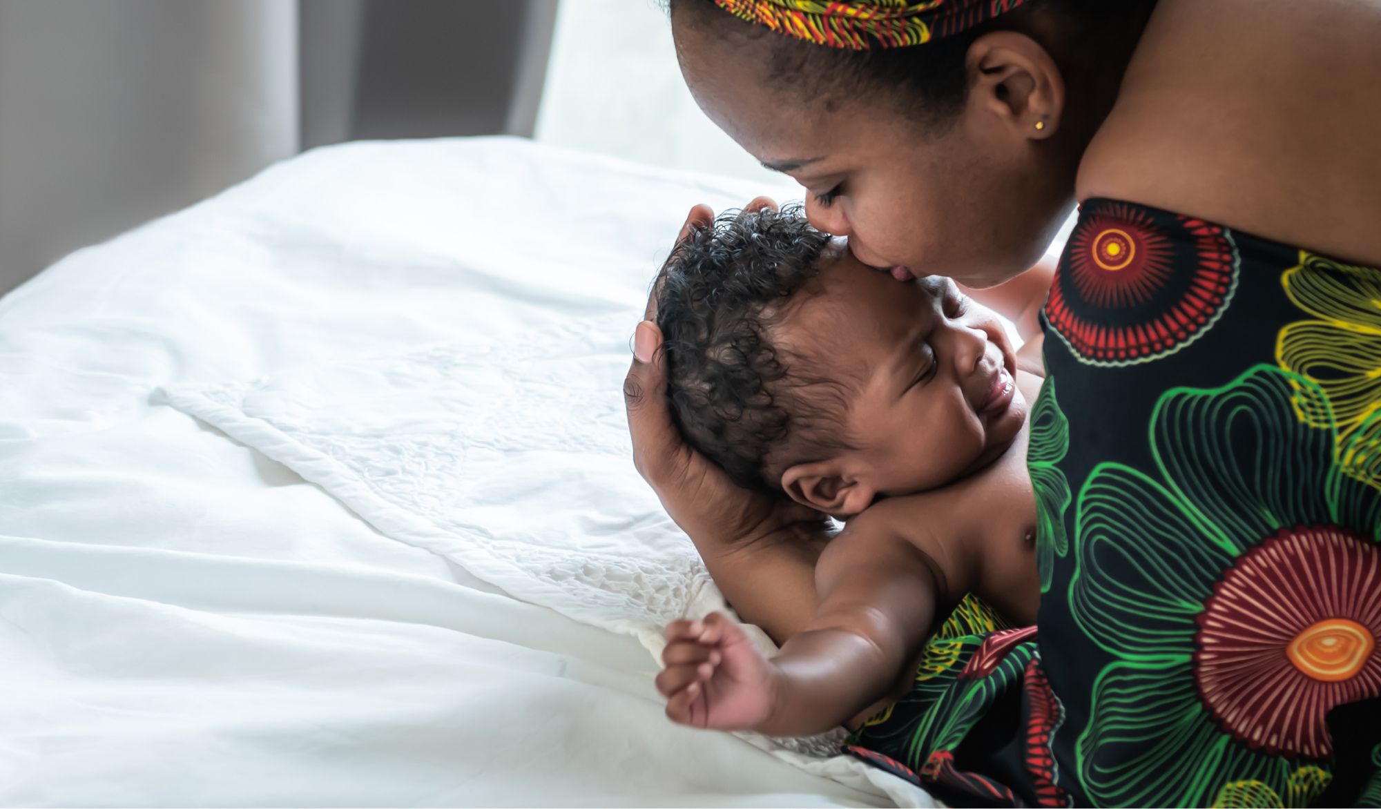 woman kissing baby